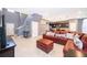 Open living room with L-shaped sectional sofa and view of kitchen at 5505 Misty Oak Cir, Davenport, FL 33837