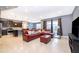 Open living room with L-shaped sectional sofa and view of kitchen at 5505 Misty Oak Cir, Davenport, FL 33837