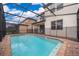 Large screened-in pool with brick patio at 5505 Misty Oak Cir, Davenport, FL 33837