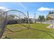 Backyard featuring batting cage and trampoline at 7804 Acadian Dr, Orlando, FL 32822