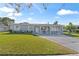 Ranch-style home with a well-maintained lawn and driveway at 7804 Acadian Dr, Orlando, FL 32822