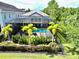 Aerial view of screened in in-ground pool with a fenced yard and green lawn at 8162 Valhalla Ter, Reunion, FL 34747