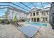 Resort-style backyard oasis featuring a large pool, ping pong table, and covered patio at 8162 Valhalla Ter, Reunion, FL 34747