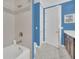 Clean bathroom with shower/tub combo and dark brown vanity at 8162 Valhalla Ter, Reunion, FL 34747