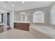 Spa-like bathroom with soaking tub, double vanity, and large mirror at 8162 Valhalla Ter, Reunion, FL 34747