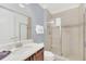 Bathroom features a single vanity, a large mirror, and shower at 8162 Valhalla Ter, Reunion, FL 34747