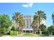 Luxury high-rise building with palm trees and manicured landscaping at 8162 Valhalla Ter, Reunion, FL 34747