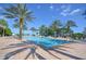 Relaxing community pool with palm trees and lounge chairs at 8162 Valhalla Ter, Reunion, FL 34747