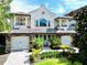 Charming two-story home featuring a well-manicured front yard and a two-car garage at 8162 Valhalla Ter, Reunion, FL 34747