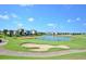 Scenic view of a golf course and lakefront homes at 8162 Valhalla Ter, Reunion, FL 34747