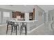 Modern kitchen with dark cabinets, white countertops, and breakfast bar at 8162 Valhalla Ter, Reunion, FL 34747