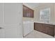 Bright laundry room with washer, dryer, and ample cabinetry at 8162 Valhalla Ter, Reunion, FL 34747