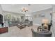 Spacious living room with comfortable seating, large TV, and pool view at 8162 Valhalla Ter, Reunion, FL 34747