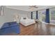 Spacious main bedroom with a king-size bed, hardwood floors, and private balcony access at 8162 Valhalla Ter, Reunion, FL 34747