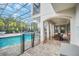 Enclosed pool area with patio furniture and a table at 8162 Valhalla Ter, Reunion, FL 34747
