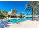 Large resort-style pool with a sundeck and palm trees at 8162 Valhalla Ter, Reunion, FL 34747