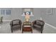 Cozy sitting area with two armchairs and a glass-top table at 8162 Valhalla Ter, Reunion, FL 34747