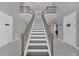 Grand staircase with dark wood and metal railings at 8162 Valhalla Ter, Reunion, FL 34747