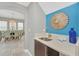 Convenient wet bar with a sink, ample counter space, and stylish mirror at 8162 Valhalla Ter, Reunion, FL 34747