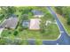An aerial view showcasing a house with a pool and lush landscaping at 26 Lake Diamond Ave, Ocala, FL 34472