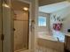 Bathroom with shower, bathtub, and double vanity at 26 Lake Diamond Ave, Ocala, FL 34472