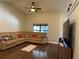 Bright living room with hardwood floors and sectional sofa at 26 Lake Diamond Ave, Ocala, FL 34472