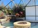 Enclosed pool area with fire pit and waterfall feature at 26 Lake Diamond Ave, Ocala, FL 34472