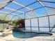 Enclosed pool and spa with a stone fire pit feature at 26 Lake Diamond Ave, Ocala, FL 34472