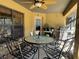 Relaxing screened patio with table, chairs, and grill at 26 Lake Diamond Ave, Ocala, FL 34472