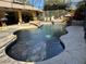 Freeform swimming pool with a fire pit and waterfall at 26 Lake Diamond Ave, Ocala, FL 34472