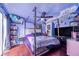 Bedroom with canopy bed, TV and purple walls at 103 Las Flores, Winter Haven, FL 33884