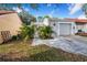 House exterior showcasing a well-maintained front yard and attached garage at 103 Las Flores, Winter Haven, FL 33884