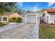 Front view of a house with a driveway and garage at 103 Las Flores, Winter Haven, FL 33884