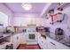 Modern kitchen featuring white cabinets, granite counters, and stainless steel appliances at 103 Las Flores, Winter Haven, FL 33884