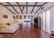 Living room with hardwood floors, exposed beams, and comfortable seating at 103 Las Flores, Winter Haven, FL 33884