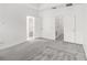 Spacious bedroom with multiple closet access points, neutral paint, and plush carpet at 1311 E 10Th St, Apopka, FL 32703