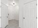 Bright hallway with white tile flooring leads to the front door and features access to additional rooms at 1311 E 10Th St, Apopka, FL 32703