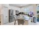 Well-lit kitchen featuring granite countertops, stainless steel appliances, and white cabinets at 1311 E 10Th St, Apopka, FL 32703