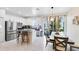 Well-lit kitchen featuring stainless steel appliances, a kitchen island with bar seating, and an adjacent dining area at 1311 E 10Th St, Apopka, FL 32703