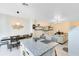 Open-concept kitchen with island seating, granite countertops, stainless appliances, and dining area at 1311 E 10Th St, Apopka, FL 32703