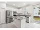 Modern kitchen with stainless steel appliances, granite countertops, and white cabinetry at 1311 E 10Th St, Apopka, FL 32703