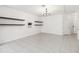 Bright living room showing a spacious floor plan, floating shelves, and easy access to other areas of the home at 1311 E 10Th St, Apopka, FL 32703