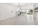 Open-concept living space with sleek tile flooring and easy access to the kitchen and backyard at 1311 E 10Th St, Apopka, FL 32703