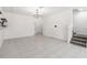 Expansive living area showcasing a sleek tile floor, with a view of the staircase, and ample room for furniture at 1311 E 10Th St, Apopka, FL 32703