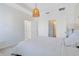 Comfortable bedroom with a stylish light fixture, tray ceiling, and en suite bathroom access at 1311 E 10Th St, Apopka, FL 32703