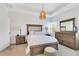 Cozy bedroom with a wooden bedframe, matching nightstands, and dresser set against neutral walls at 1311 E 10Th St, Apopka, FL 32703