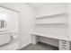 Office space with a desk, shiplap wall with shelves, and attached bathroom at 1311 E 10Th St, Apopka, FL 32703