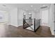 Upstairs hallway with dark wood floors and an iron railing at 13282 Bromborough Dr, Orlando, FL 32832