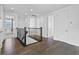 Upstairs hallway with dark wood floors and an iron railing at 13282 Bromborough Dr, Orlando, FL 32832