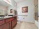 Bathroom with granite countertop, dark wood cabinets, and shower/tub combo at 1361 Tuscan Ter # 7305, Davenport, FL 33896